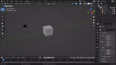 Interface du logiciel Blender affichant un cube en 3D dans le viewport pour la modélisation d'assets